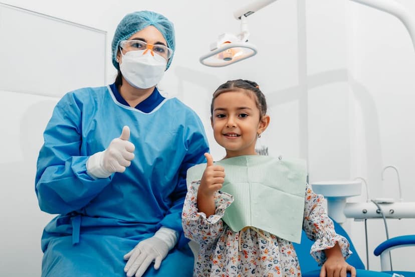 Child giving thumbs up at the dentist
